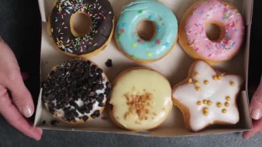 in the frame is a box with six different donuts
