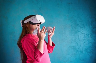 little girl playing with virtual reality glasses