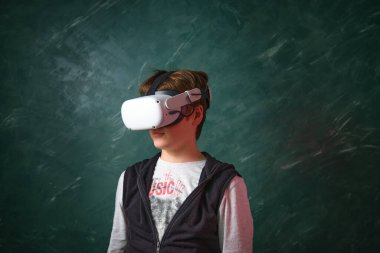 a boy playing with virtual reality glasses