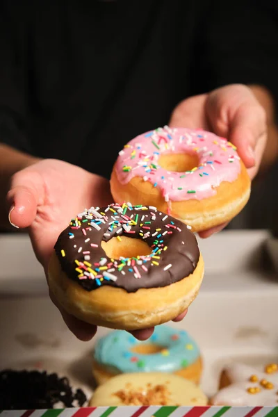 Two Donuts Chocolate Multi Colored Sprinkling Womans Hand — Foto de Stock