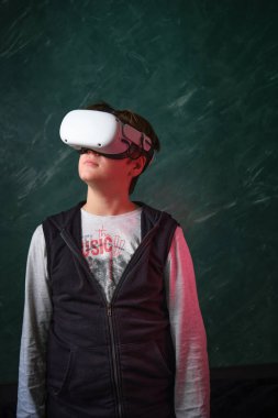 a boy playing with virtual reality glasses