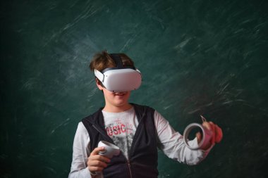 a boy playing with virtual reality glasses