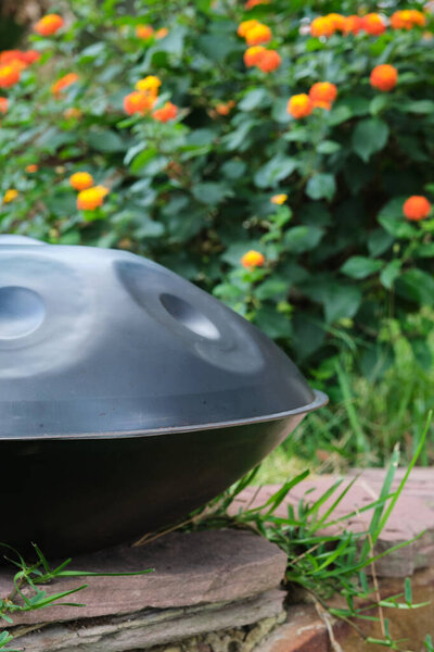 hang or handpan on the grass in the garden