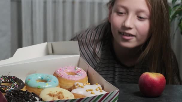 Een Meisje Met Een Doos Zoete Heerlijke Donuts — Stockvideo