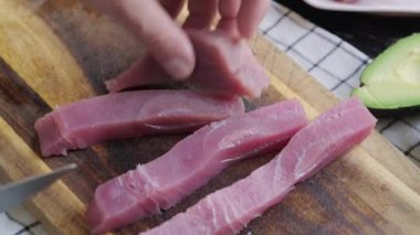 Sliced fresh tuna for sushi on a cutting board