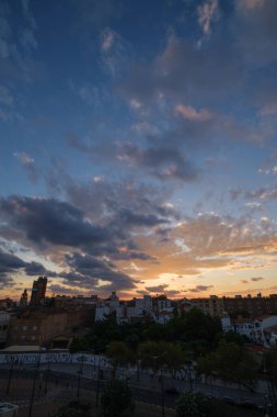 cityscape sunset clouds over the evening city Valencia, Spain clipart