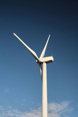 Arka planda mavi gökyüzü olan rüzgar türbini kapat