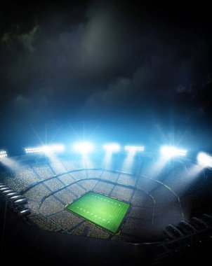 Geceleyin boş bir sahayla aydınlanan Amerikan Futbol Stadyumu.