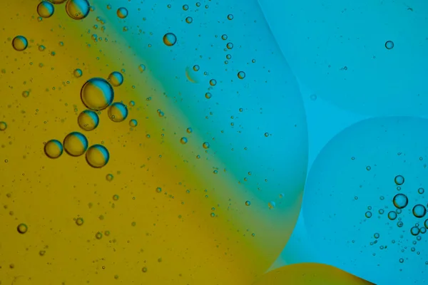 Top view oil bubbles drop on the water with colorful background, Macro photography concept