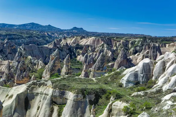 Cappadocia landscape soft volcanic rock, shaped by erosion into towers.