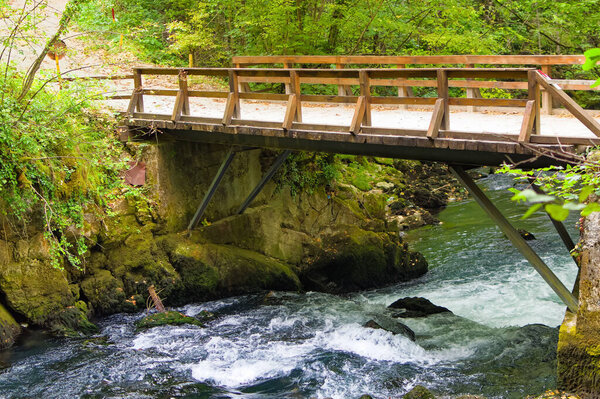 Wooden bridge over mountain river in Bosnia and Herzegovina.
