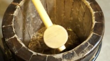 Super slow motion of hitting mortar pestle on pepper seeds. 