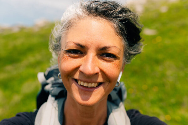 happy hiker woman taking selfie in the mountains. High quality photo