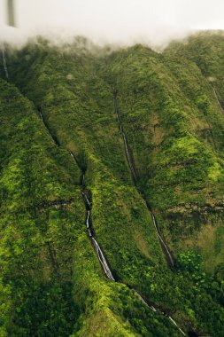 Helikopterden görüldüğü gibi kauai dağlarının etrafında dönen bulutlar. Yüksek kalite fotoğraf