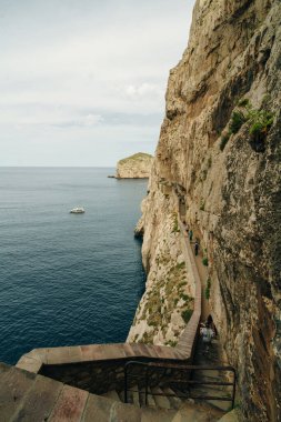 Stairs towards the cave of Grotta di Nettuno, Sardinia, Italy - may 2 2024. High quality photo clipart