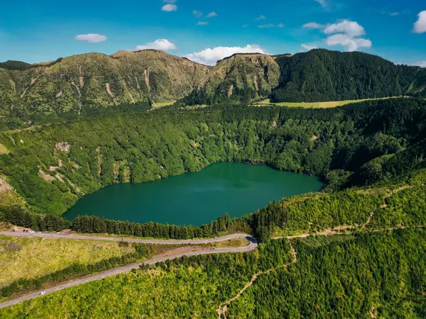 stock image road to Lagoa de Santiago, green terrain, and winding road, Sao Miguel, Azores. High quality 4k footage