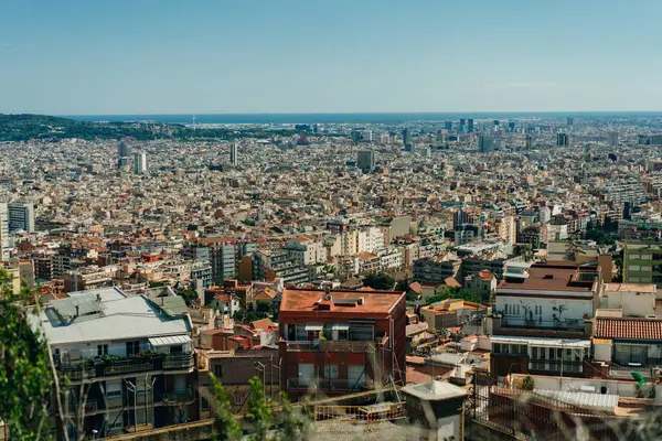 stock image people look at the view of the city from the Bunkers del Carmel on a clear sky in Barcelona, Spain - may 2 2024. High quality photo