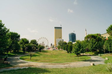 TIRANA, ALBANIA, SEPTEMBER 29, 2023 People are strolling in front of the Skanderbeg memorial and Ethem Bey mosque in Tirana, Albania. High quality photo clipart