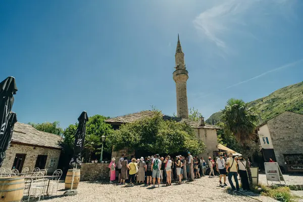 stock image street with local shops and shoppers in Mostar, flanked by traditional architecture - July 10, 2024. High quality photo