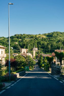 Sentiero degli Dei (Path of the Gods). Village and wind wind turbine along the Path of the Gods. San Benedetto val di Sambro, Bologna Province, Emilia Romagna, Italy. High quality photo clipart