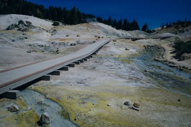 Bumpass Hell is the largest hydrothermal site in Mt. Lassen park. It's the main area of upflow of steam and discharge from the Lassen hydrothermal system. Mount Lassen is an active California Volcano. clipart