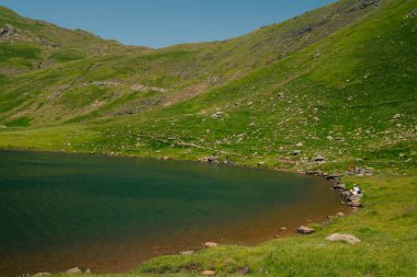 An alpine lake Gentau is one of Ayous lakes in the Atlantic Pyrenees. . High quality photo clipart