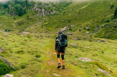 girl Hiker on countryside landscape in the Pyrenees, Pyrenees in France. High quality photo clipart