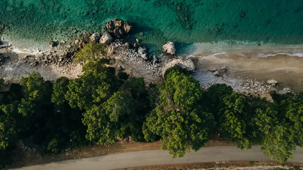 Yazın günbatımında hava manzaralı mavi deniz. İnsanlı tropik manzara, temiz su, taşlar, kumlu plaj. Yüksek kalite fotoğraf