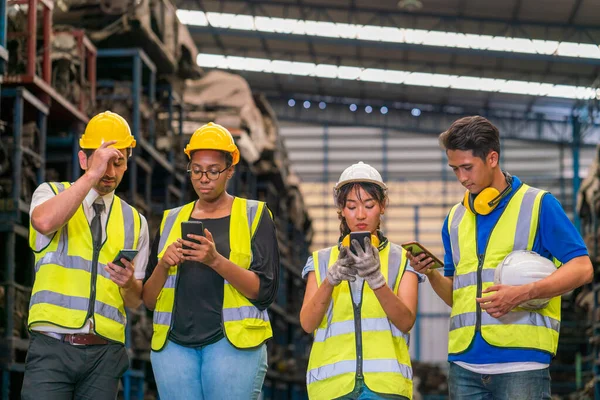 エンジニアや技術者は倉庫や工場で自動車部品を検査しています 携帯電話を用いた工場技術者 — ストック写真
