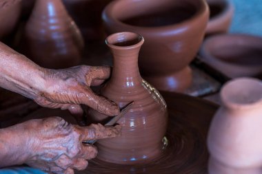 Make a clay mortar Thai. Hands of a potter at work. making ceramic mug.
