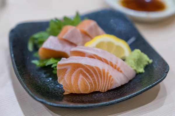 Japan raw salmon slice or salmon sashimi in japanese style. Salmon sasimi on disc.