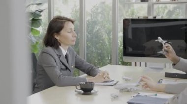 Modern ofiste dizüstü bilgisayarları ve belgeleriyle çalışan genç ve mutlu meslektaşlar. Havayolu çalışanları toplantı odasında..