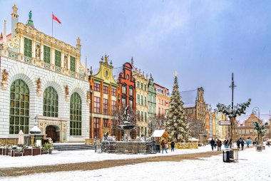 Gdansk, Poland - January 20, 2022: Beautiful colourful Christmas cityscape in Gdansk. Ancient historical buildings and a decorated Christmas tree. Winter holidays in Poland