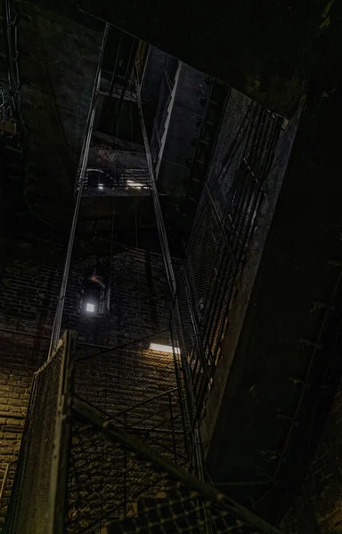 stock image Old grunge metal staircase in the dark ancient tower