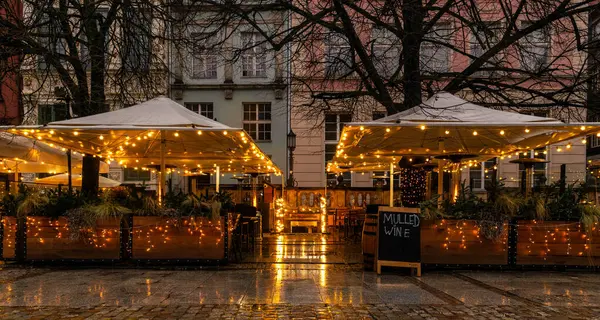 Beautiful shiny sidewalk cafe in the winter city