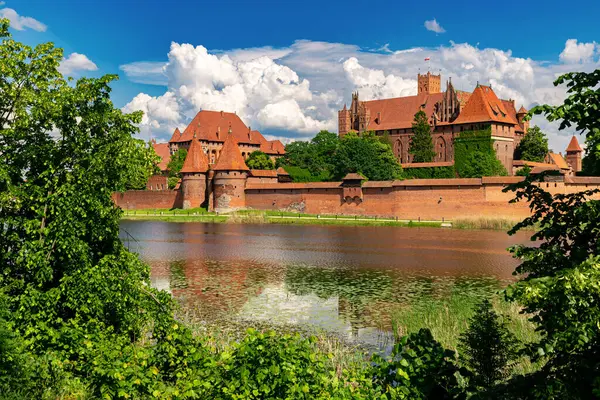 stock image Malbork, Poland - May 25, 2024: Medieval capital of the Teutonic Knights, gothic brick castle Malbork in Poland. Popular tourist attraction and UNESCO heritage site