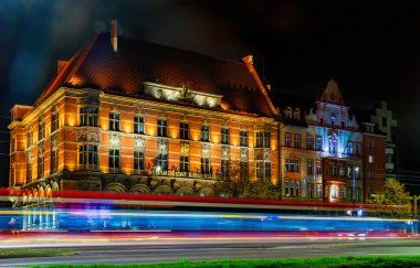 Gdansk, Poland - October 29, 2024: historic building of Narodowy Bank Polski in the Old Town of Gdansk. Beautiful night cityscape with taillights clipart