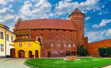 Gdansk, Poland - October 12, 2024: Beautiful medieval town in Eastern Europe. Ancient gothic castle in Olsztyn, Poland. Prussian brick gothic architecture clipart