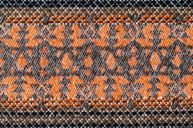 Geometrik desenli geleneksel kahverengi ve turuncu yün paspas dokusu