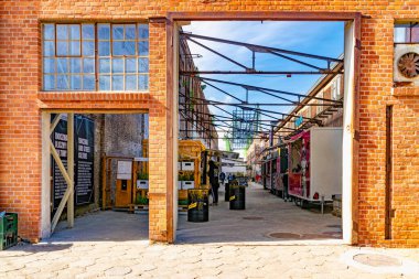 Gdansk, Polonya - 10 Mayıs 2025: Gdansk 'taki tarihi tersanenin ünlü turizm ve eğlence alanı. Yıkılan sanayi binaları, vinçler ve gıda alanları