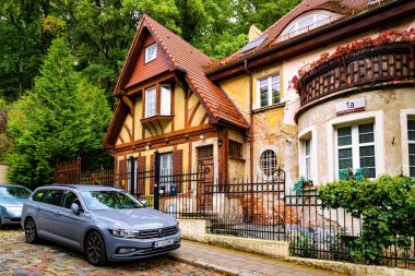 Gdansk, Poland - October 05, 2025: Beautiful old half-timbered houses in the historic residential district in Gdansk. Narrow street with parked cars and colourful cottages