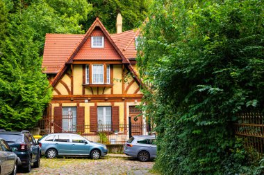 Gdansk, Poland - October 05, 2025: Beautiful old half-timbered houses in the historic residential district in Gdansk. Narrow street with parked cars and colourful cottages