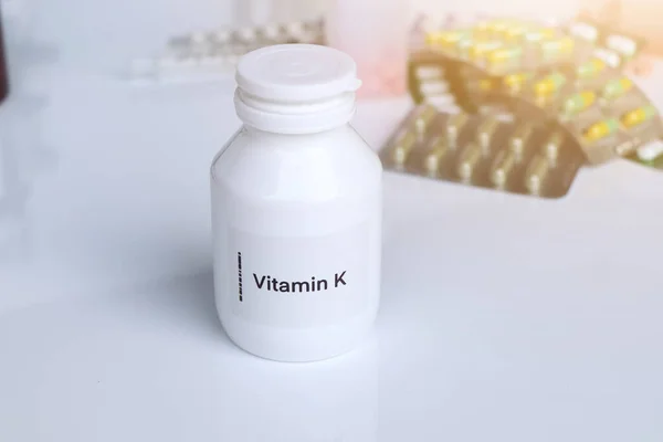 Vitamin K pills in a bottle, food supplement for health or used to treat disease