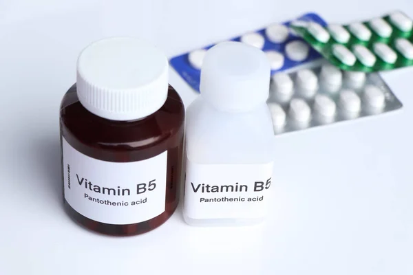 Vitamin B5 pills in a bottle, food supplement for health or used to treat disease