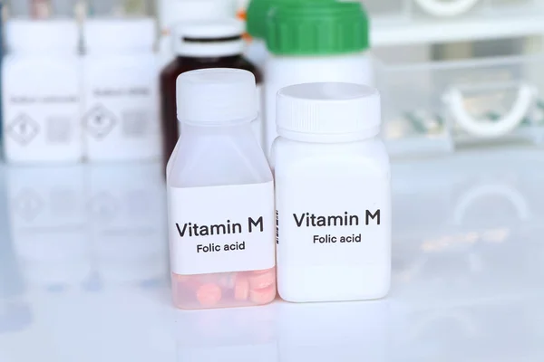 stock image Vitamin M pills in a bottle, food supplement for health or used to treat disease