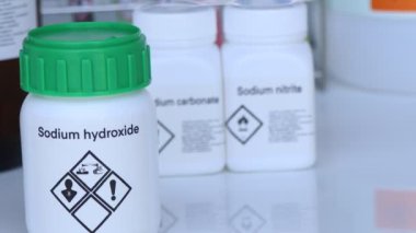 Sodium hydroxide in glass, chemical in the laboratory and industry