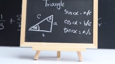 Blackboard with hand written geometry area formulas and geometric shapes and figures