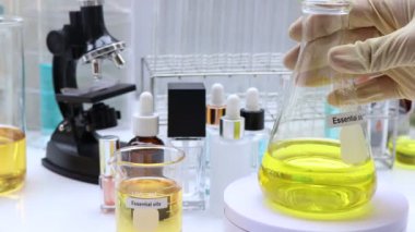 Essential oil in Glass Bottle, yellow Essential oil, bottles of Essential on background