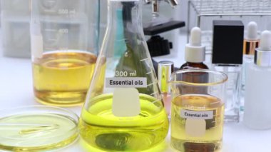 Essential oil in Glass Bottle, yellow Essential oil, bottles of Essential on background
