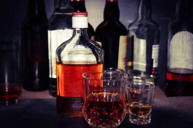 red strong alcohol drinks, hard liquors, spirits and distillates iset in glasses